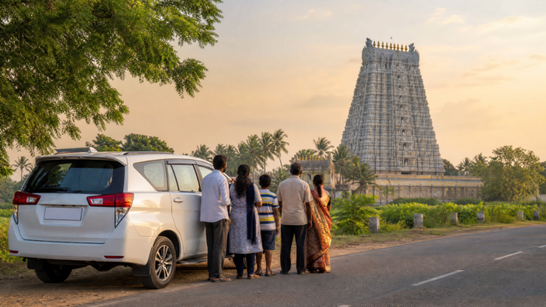 Family standing beside a seven-seater car near a South Indian temple gopuram during a Tamil Nadu temple tour by road trip at sunset.